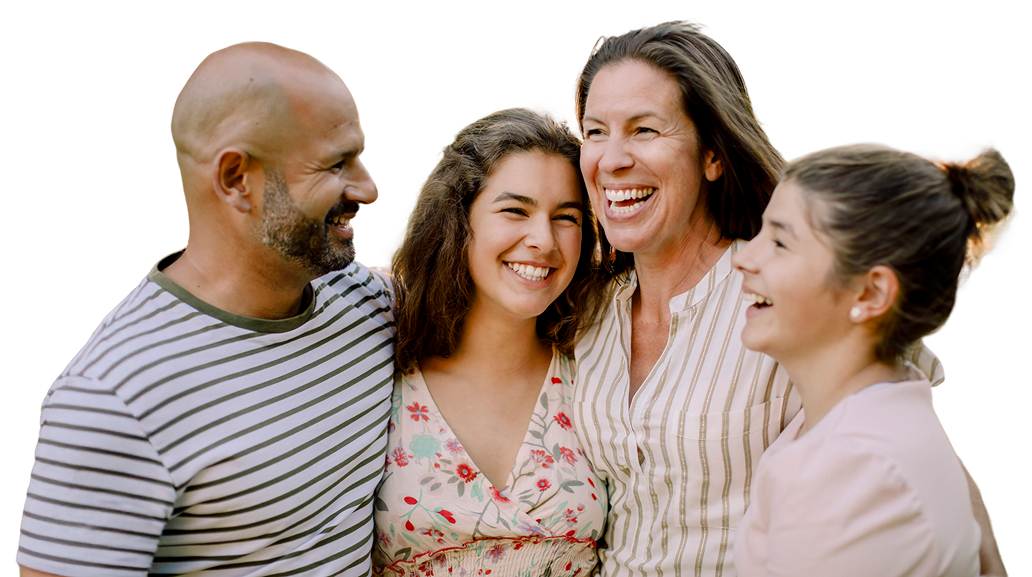 Happy family of four smiling and hugging